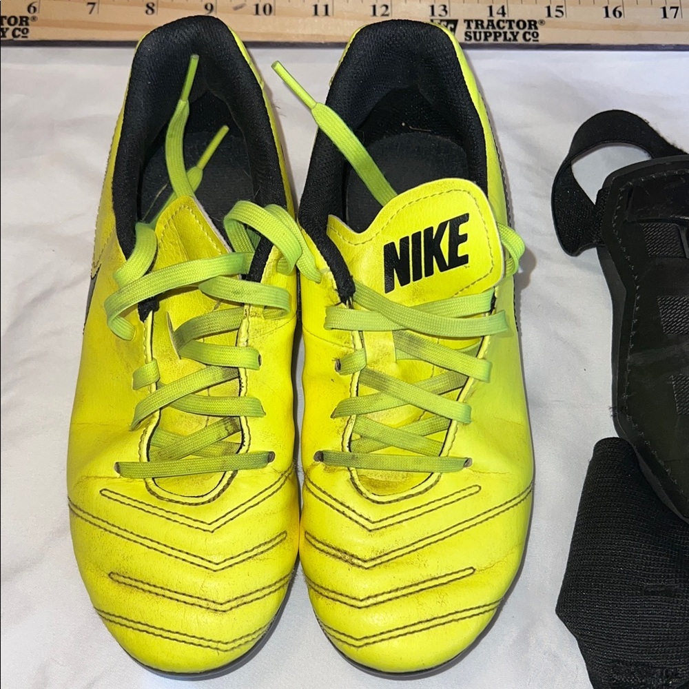 Nike Tiempo Kids Neon Yellow Cleats with leg guards. Size 3.5 Youth